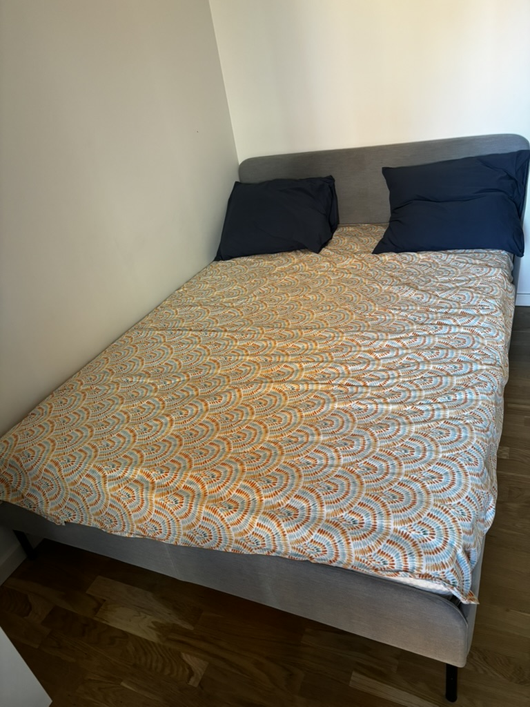 Double bed with grey upholstered frame